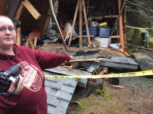 Cheyenne Girmscheid points out damage to her family&rsquo;s home after a drunk driver crashed into her sister&rsquo;s bedroom Friday evening. (Kevin Gullufsen | Juneau Empire)