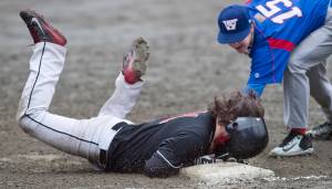 Juneau-Douglas&rsquo; Niko Hebert slides safely into third base against Sitka&rsquo;s Bryce Kelly in the second game of a double-header at Adair-Kennedy Memorial Park on Saturday, May 13, 2017. (Michael Penn | Juneau Empire)