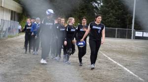 The Thunder Mountain High School softball team forms a handshake line after Saturday morning&rsquo;s 8-0 win over Sitka. (Nolin Ainsworth | Juneau Empire)