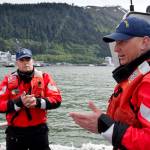 Executive Petty Officer Joshua Link, right, and Petty Officer First Class Garrett Borden talk about boating safety while on a U.S. Coast Guard 45-foot response boat in Juneau&rsquo;s downtown harbor on Wednesday.