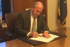 Gov. Bill Walker signs a special session proclamation Wednesday night, May 17, 2017 in his office on the third floor of the Alaska Capitol (James Brooks | Juneau Empire)
