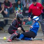 MICHAEL PENN | JUNEAU EMPIRE Thunder Mountain&rsquo;s Rachel Macaulay, right, slides safely home as the ball gets away from Juneau-Douglas&rsquo; catcher Morgan Balovich during their game at Melvin Park on Friday.