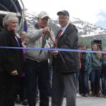 From left, Sharon Pusich Gill, Louie Pusich and Mayor Ken Koelsch lead the ribbon-cutting ceremony for the new Mike Pusich Douglas Harbor on Friday. The city completed renovations on the harbor this spring, which now carries the name of the former Douglas mayor who first advocated for the harbor. (Alex McCarthy | Juneau Empire)