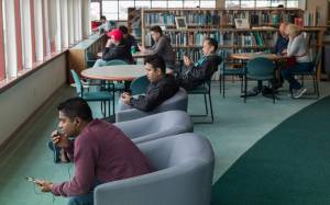 Visitors make use of the free internet connection at the Downtown Public Library on Tuesday, May 30, 2017. A city budget meeting on Tuesday is looking at possible cuts to libraries to help balance the budget. (Michael Penn | Juneau Empire)