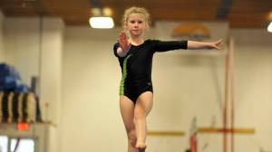 Addie Buss competes on the balance beam at the Yukon Gymnastics Championships in Whitehorse, Yukon, Sunday, May 28. (Tom Patrick | Yukon News)
