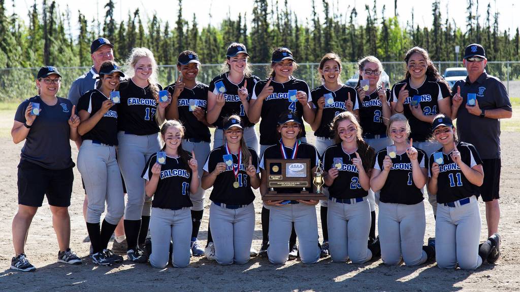 The Thunder Mountain High School softball team poses with the state small schools softball championship trophy, Saturday, June 3, in Fairbanks. Top row: Coach Brittany Gladsjo, Coach Brian Dallas, Maxie Saceda-Hurt, Megan Dallas, Kyra Jenkins Hayes, Peyton Harp, Nina Fenumiai, Alice Duncan, Morgan Poole, Tasi Fenumiai, Coach John Boucher. Bottom row: Winter Clancy, Haleigh DiCarlo, Alondra Echiverri, Kaitlyn Jansen, Rachel Macaulay, Gabrielle Scales. (Sarah Manriquez | For the Juneau Empire)