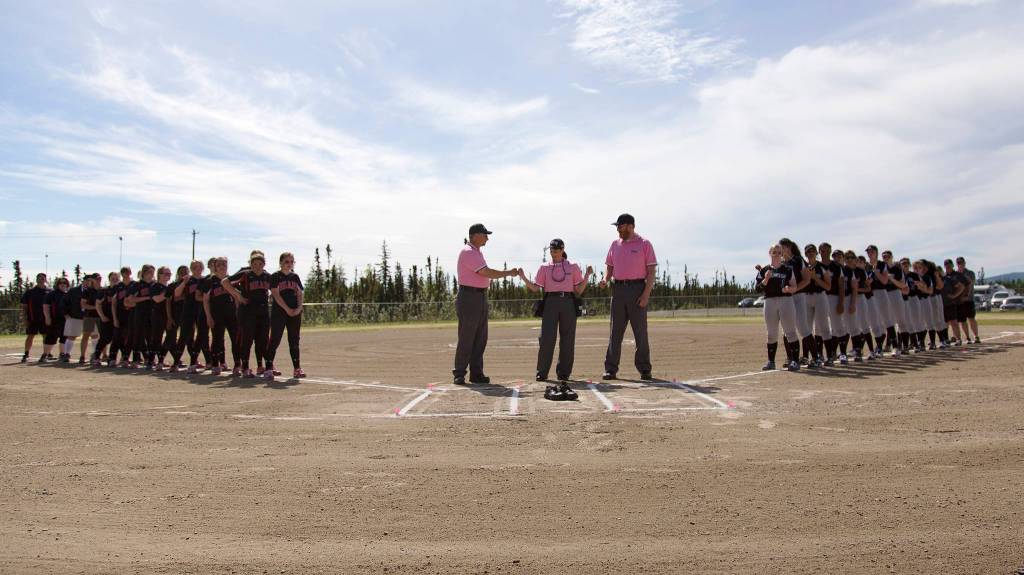 The Juneau-Douglas and Thunder Mountain High School softball teams line up before the start of the final game for the 2017 ASAA State Small Schools Softball Championship game on Saturday, June 3, at the South Davis Park Complex in Fairbanks. (Sarah Manriquez | For the Juneau Empire)