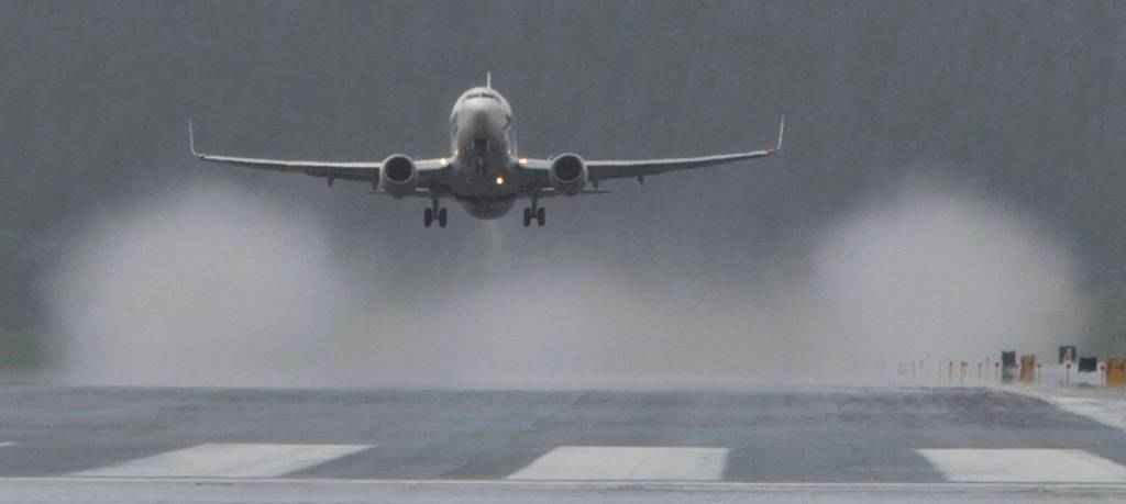 Rain vortexes are created behind an Alaska Airline 737 passenger jet as it takes off at the Juneau International Airport on Tuesday, June 20, 2017. (Michael Penn | Juneau Empire)