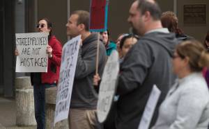 Tony Warren, a state employee at the Department of Education and Early Development, left, stands with other state workers during noon rally against the Legislature&rsquo;s lack of a budget on Thursday, June 22, 2017. (Michael Penn | Juneau Empire)