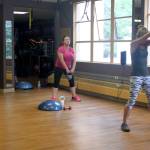 Students in the HIIT (High Intensity Interval Training) class at Mountainside Wellness strengthen threir core muscles during a kettlebell exercise Monday afternoon. (Erin Granger | Juneau Empire)
