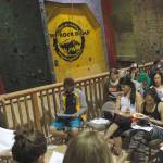 Rock Dump Gym board member Gabe Hayden speaks to a crowd of members Tuesday night. Hayden and the other board members explained that to continue to stay in its current location, the gym needs to find ways to make more money. (Alex McCarthy | Juneau Empire)