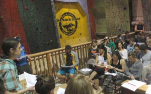 Rock Dump Gym board member Gabe Hayden speaks to a crowd of members Tuesday night. Hayden and the other board members explained that to continue to stay in its current location, the gym needs to find ways to make more money. (Alex McCarthy | Juneau Empire)