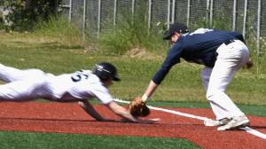 Juneau Post 25&rsquo;s Bryce Swofford tags out a Chugiak base runner on Sunday, June 25, at Oberg Field in Chugiak. (Photo courtesy of Jeremy Ludeman)