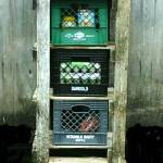 The finished outdoor cooler made from a wooden ladder, beachcombed dairy crates, handmade shakes, and part of a shipwreck.