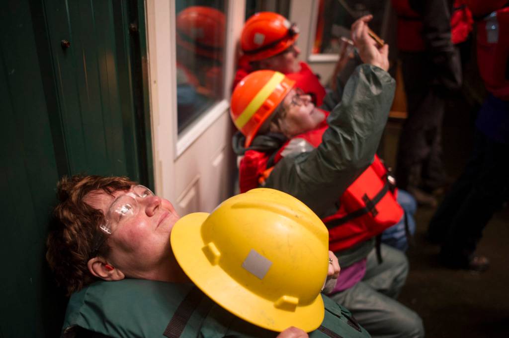 Peggy Reddy watches the fireworks from the barge with other volunteers during the annual city-funded fireworks show in Juneau&rsquo;s downtown harbor on Tuesday, July 3, 2017. (Michael Penn | Juneau Empire)