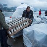 Volunteers Sam Cartmill, left, and Ian Dinneford carry rocket launchers into place before the annual city-funded fireworks show in Juneau&rsquo;s downtown harbor on Tuesday, July 3, 2017. (Michael Penn | Juneau Empire)