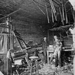 Interior of the bank after the attempted robbery. Charles Pooley is on the right and possibly George Wallace is on the left. Photo courtesy of the Klondike Gold Rush Historical Park. Photo taken on Sept. 15, 1902 by William H. Case and Horace H. Draper.