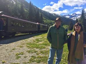 Paul Theroux with wife Sheila by the White Pass Railway train tracks. Image courtesy of Katie Bausler.