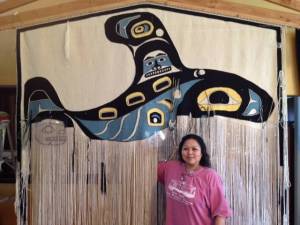 Anna Brown Ehlers and the Killer Whale Chilkat blanket, the longest Chilkat blanket in history. It&rsquo;s eight feet wide and seven feet long. Courtesy image.