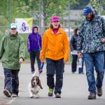 In this 2014 file photo, Kim Campbell, dog Frazier, Melanie White, and Bill Campbell walk laps during the Relay for Life at Riverbend Elementary School. (Marlena Sloss | Juneau Empire)