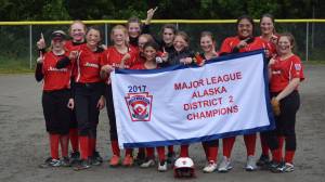 The Gastineau Channel Little League Major Softball All-Stars celebrate their District 2 championship at Melvin Park, Saturday, July 8. Left to right: Anna Dale, Aspen Kasper, Kiah Yadao, Sydney Strong, Riley Harp, Moriah Schauwecker, Tristan Oliva, Tyler Johnson, Zoey Billings, Gloria Bixby, Tahila Kuma, Peyton Carson, Ruby Davis. The team plays in the state tournament beginning Thursday. (Nolin Ainsworth | Juneau Empire)