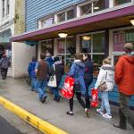 Tourists walk by The Glory Hole, Juneau&rsquo;s soup kitchen and homeless shelter, on Tuesday, July 11, 2017. The city is considering moving The Glory Hole out of downtown. (Michael Penn | Juneau Empire)