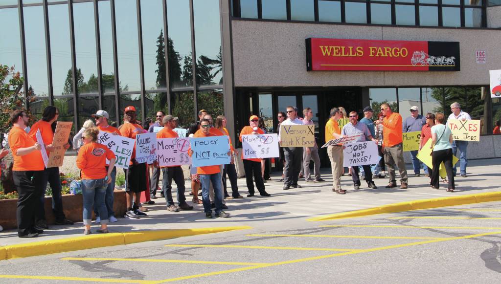 Elwood Brehmer | alaska journal of commerce Members of Laborers Local 341 in orange shirts and others supporting the Alaska oil industry rallied against House Majority proposals to raise taxes before a hearing at the Legislative Information Office in Anchorage on Wednesday.