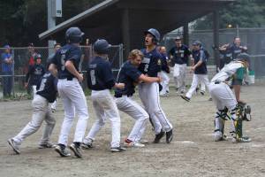 Owen Mendoza scores the winning run in Juneau Post 25&rsquo;s walk-off 4-3 victory over Service Post 28 Saturday at Adair-Kennedy Memorial Park. Mendoza scored from first base on Alex Muir&rsquo;s game-winning double. (Alex McCarthy | Juneau Empire)