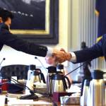 Rep. Neal Foster, D-Nome, left, shakes hands with Sen. Lyman Hoffman, D-Bethel, after an agreement is made on the capital budget in conference committee at the Capitol on Thursday, July 27, 2017. (Michael Penn | Juneau Empire)