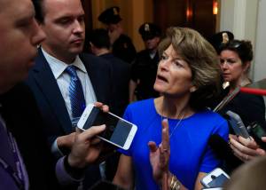 Sen. Lisa Murkowski, R-Alaska is surrounded by reporters as she walks toward the Senate floor on Capitol Hill in Washington, Tuesday, July 18, 2017. (Manuel Balce Ceneta | The Associated Press)