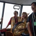 Raymond Gregory, left, Fausto Paulo, Jeannie Lee and Andy Ebona sing during the Douglas Indian Association&rsquo;s boat trip to Taku Inlet to view traditional village sites on Friday, July 28, 2017.