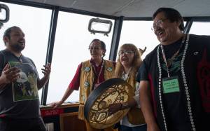 Raymond Gregory, left, Fausto Paulo, Jeannie Lee and Andy Ebona sing during the Douglas Indian Association&rsquo;s boat trip to Taku Inlet to view traditional village sites on Friday, July 28, 2017.