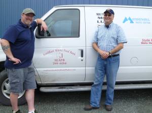 Adams and Watson stand in front of the food bank&rsquo;s delivery/pick-up van. Photo by Mackenzie Fisher.