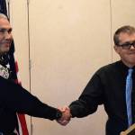 Juneau Police Department Chief Ed Mercer is congratulated by City Manager Rorie Watt after his swearing-in Monday. (Liz Kellar | Juneau Empire)