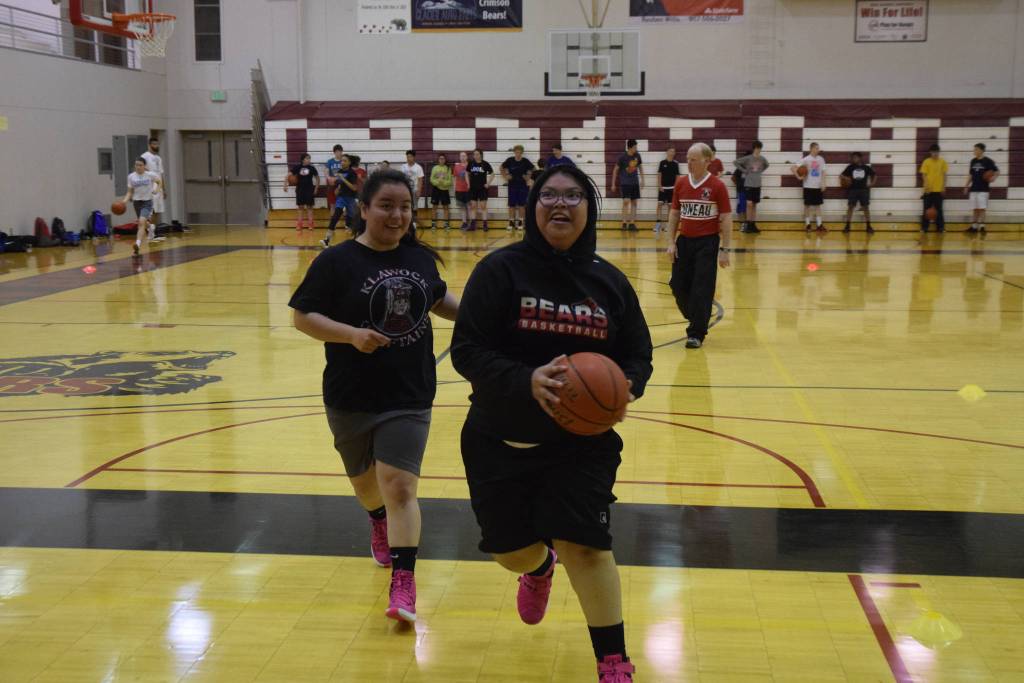 Two campers participate in a drill Wednesday morning at the Carlos Boozer Basketball Camp at the Juneau-Douglas High School gym. Approximately 160 kids are participating in the week-long camp featuring Boozer and Doug Plumb of Academy Basketball in Vancouver. (Nolin Ainsworth | Juneau Empire)