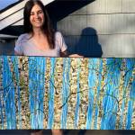 Debby Bloom holds one of her paintings that will be featured at Coppa in Juneau. Courtesy image.