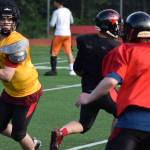 Quarterback Bubba Stults rolls out of the pocket during Juneau-Douglas High School football practice on Tuesday, July 1. (Nolin Ainsworth | Juneau Empire)