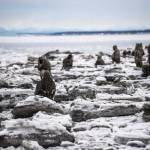 Figures stand at Point Woronzof in the winter of 2015 as part of an art installation by Sarah Davies called 100Stone. (Photo by Michael Conti)