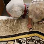 Weavers Delores Churchill (left) and Kay Field Parker examine a Chilkat robe that was donated to Sealaska Heritage Institute. The robe is estimated to be from the late 1800s or late 1900s and is expected to be an important teaching tool for weavers. (Alex McCarthy | Juneau Empire)