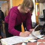 City and Borough of Juneau Assembly candidate Carole Triem puts the finishing touches on her registration for the election. This is the first time Triem has run for public office. (Alex McCarthy | Juneau Empire)