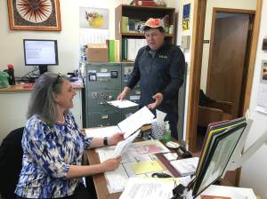 City and Borough of Juneau Assembly candidate Chuck Collins turns in his paperwork to City Clerk Laurie Sica on Monday. Collins said the people of Juneau &ldquo;need to take control of our town again.&rdquo; (Alex McCarthy | Juneau Empire)