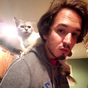 Paul Oliva is seen in an undated photo with a cat, Mishu. (Contributed photo)