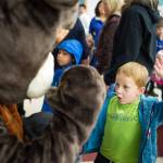 Kindergartener Leif Christianson winds up to deliver a high-five to the school mascot, The Beaver, during the first day of the school at Riverbend Elementary School on Wednesday, Aug. 16, 2017.