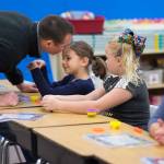 Hailey Thornton receives a kiss from her father, Justin, after he dropped her off at her second grade class on the first day of the school at Riverbend Elementary School on Wednesday, Aug. 16, 2017.