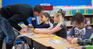 Hailey Thornton receives a kiss from her father, Justin, after he dropped her off at her second grade class on the first day of the school at Riverbend Elementary School on Wednesday, Aug. 16, 2017.