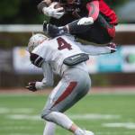 Juneau-Douglas&rsquo; Lance Galletes-Fenumiai attempts to hurdle Ketchikan&rsquo;s AJ Malouf at Adair-Kennedy Memorial Field on Saturday, Aug. 19, 2017. JDHS won 32-8. (Michael Penn | Juneau Empire)