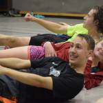 Clem Taylor-Roth and Gillian Smith do an abdominal workout. The JDHS cross country team is larger than normal this season, with approximately 60 kids on the roster according to the coaching staff. (Nolin Ainsworth | Juneau Empire)