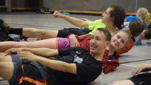 Clem Taylor-Roth and Gillian Smith do an abdominal workout. The JDHS cross country team is larger than normal this season, with approximately 60 kids on the roster according to the coaching staff. (Nolin Ainsworth | Juneau Empire)