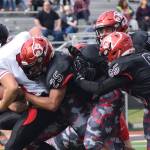 Juneau running back Liam Van Sickle gets tackled by several Kenai defenders, including James Siamani (25) and John Grossl (65) Saturday afternoon at Ed Hollier Field in Kenai. (Joey Klecka | Peninsula Clarion)