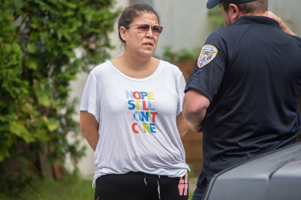 Juneau police question a woman found at James Barrett&rsquo;s house at 401 Harris Street on Tuesday, Aug. 29, 2017. (Michael Penn | Juneau Empire)